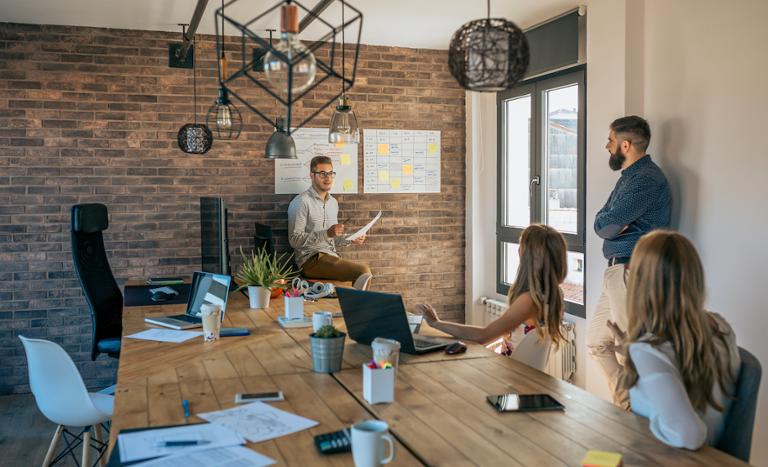 shutterstock_1565615698.jpg Product manager working with team on project creation